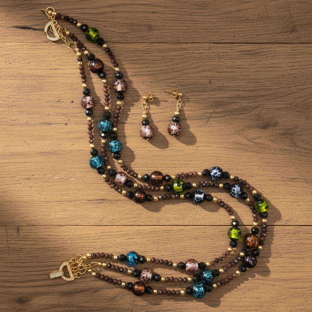Beaded necklace and earrings set on a white background