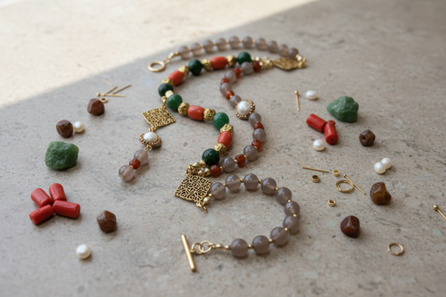 Jewelry set with beads and stones on a textured surface