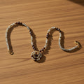Beaded necklace with gold clasp on a white background