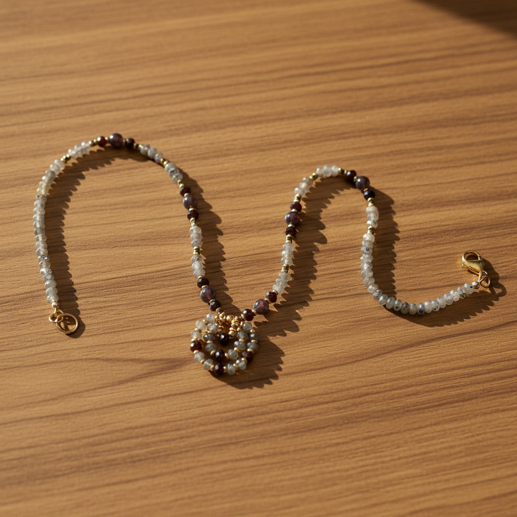 Beaded necklace with gold clasp on a white background