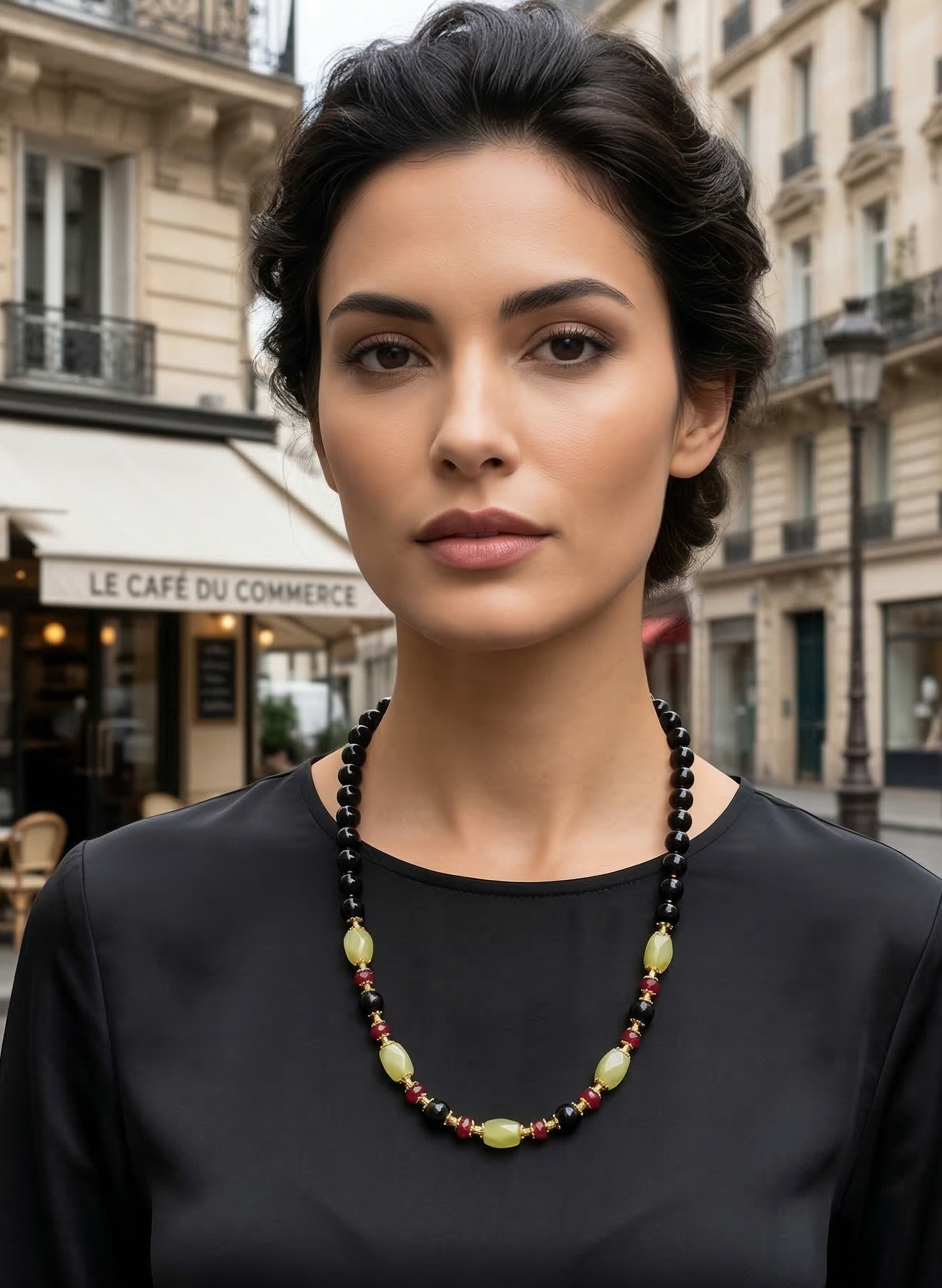 Woman wearing a black beaded necklace in an urban setting