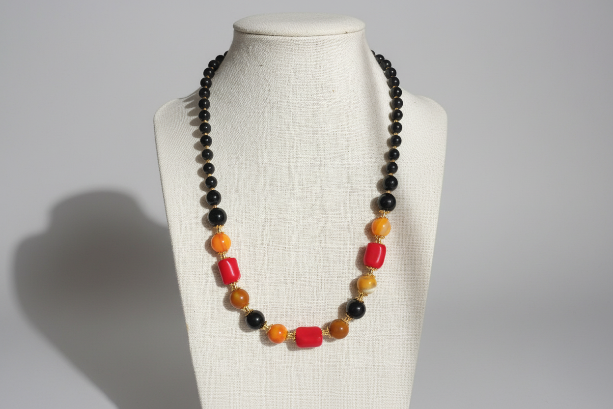 Necklace with multicolored beads on a mannequin bust against a plain background