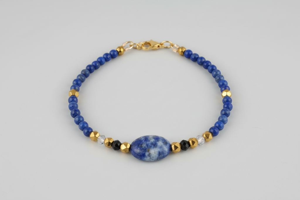 Bracelet with blue beads and gold accents on a gray background