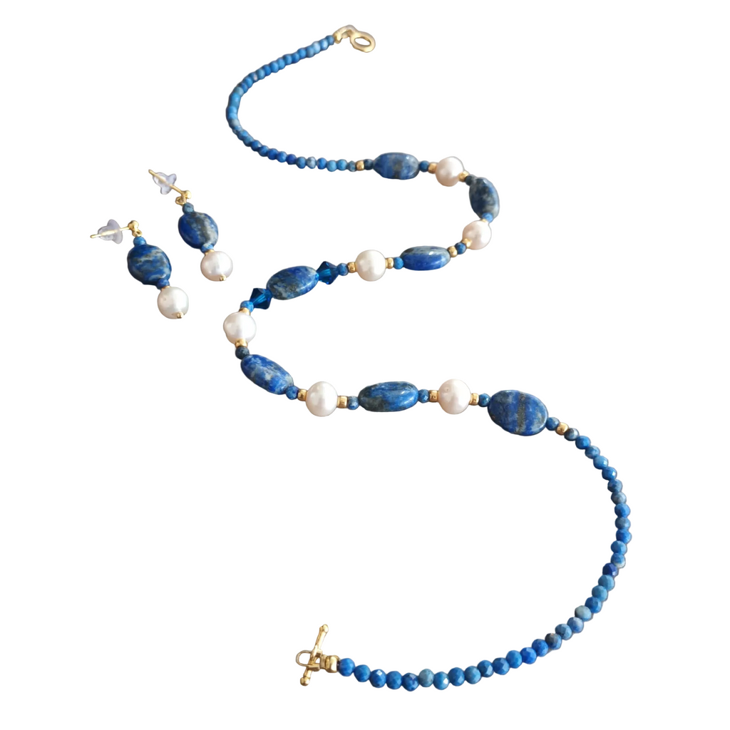 Blue beaded necklace with gold clasp on a white background