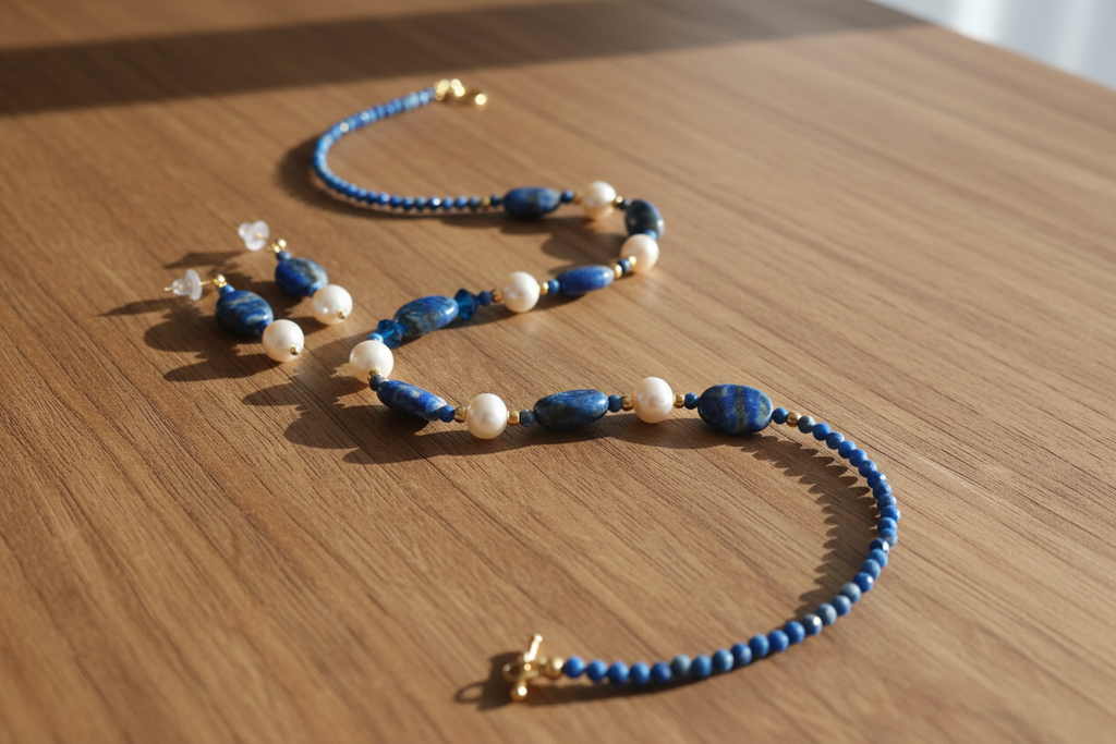 Necklace with blue and white beads on a wooden surface